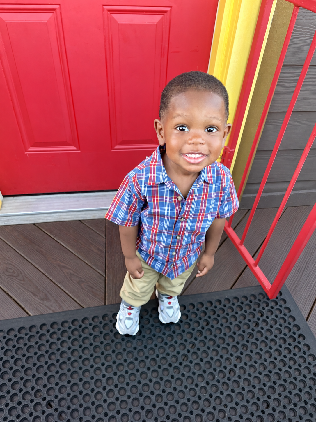 Child smiling at the center’s entrance