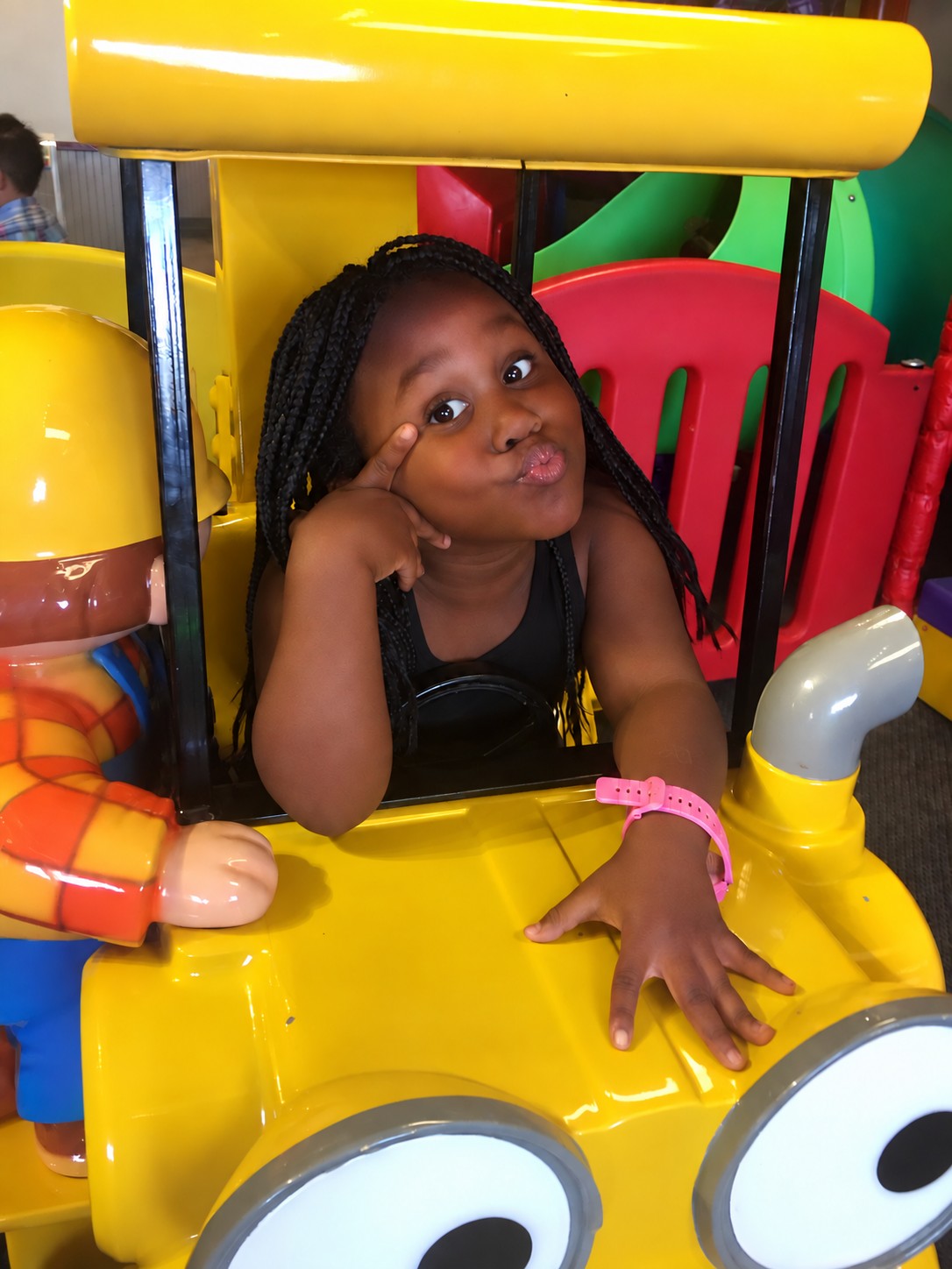 Girl enjoying the yellow classroom play car